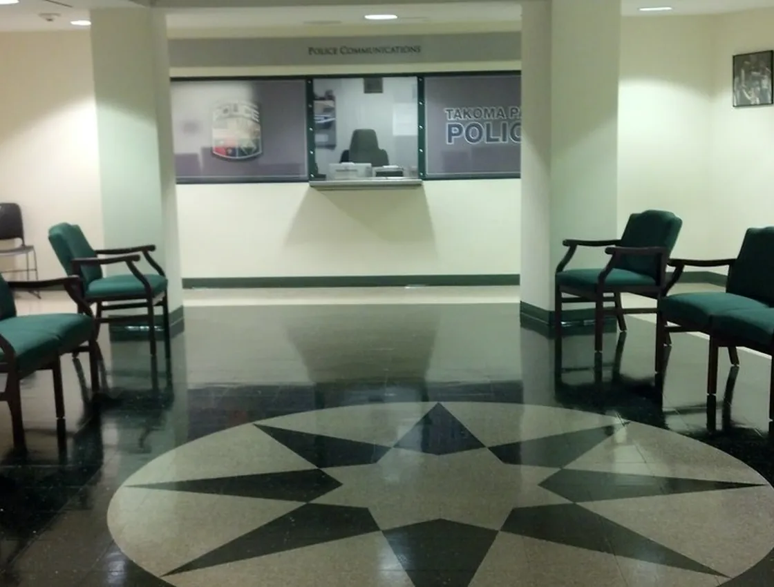 A commercial waiting room with a freshly waxed VCT floor and a high-gloss inlaid medallion.